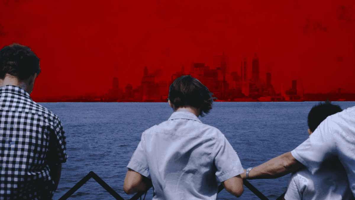 Boy Starring at the ocean with red skies